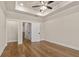 This bedroom has hardwood floors, tray ceiling, recessed lights, and a closet with double doors at 169 Wards Crossing Way # 125, Johns Creek, GA 30022