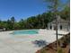 Community pool with surrounding concrete patio, and small building with the pool's pump and filter equipment at 169 Wards Crossing Way # 125, Johns Creek, GA 30022