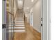 Inviting entryway with hardwood floors and staircase featuring wooden railing at 169 Wards Crossing Way # 125, Johns Creek, GA 30022