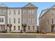 New construction townhome exterior with brick facade and iron fence at 169 Wards Crossing Way # 125, Johns Creek, GA 30022