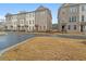 Street view of new townhomes with brick facade and wrought iron fencing at 169 Wards Crossing Way # 125, Johns Creek, GA 30022