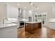 Modern kitchen featuring stainless steel appliances, wood flooring, and a center island for added counter space at 169 Wards Crossing Way # 125, Johns Creek, GA 30022