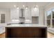 Bright kitchen with stainless steel appliances, wooden island, white cabinets, and farmhouse sink at 169 Wards Crossing Way # 125, Johns Creek, GA 30022