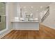 Spacious kitchen with a wooden island, white countertops, and open access to adjacent rooms at 169 Wards Crossing Way # 125, Johns Creek, GA 30022