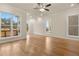 Living room with hardwood floors and large windows with views of backyard at 169 Wards Crossing Way # 125, Johns Creek, GA 30022