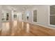 Hardwood-floored living room with multiple windows, offering ample natural light at 169 Wards Crossing Way # 125, Johns Creek, GA 30022