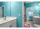 Bright bathroom featuring double vanity, framed mirror, and colorful accents at 1903 Brackendale Nw Rd, Kennesaw, GA 30152