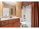 Bathroom featuring a vanity with granite countertop, a framed mirror, and a shower-tub combination at 1903 Brackendale Nw Rd, Kennesaw, GA 30152