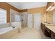 Spacious bathroom with double sink vanity, soaking tub, and glass shower at 1903 Brackendale Nw Rd, Kennesaw, GA 30152
