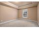 Neutral-toned bedroom with a window, carpeted floors, and fresh paint at 1903 Brackendale Nw Rd, Kennesaw, GA 30152