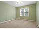 Empty bedroom with carpet and a large window at 1903 Brackendale Nw Rd, Kennesaw, GA 30152
