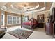 Spacious main bedroom with a sitting area, carpet, windows, and a ceiling fan at 1903 Brackendale Nw Rd, Kennesaw, GA 30152
