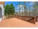 Large wooden deck with railings, offering a tranquil outdoor space surrounded by trees at 1903 Brackendale Nw Rd, Kennesaw, GA 30152