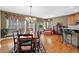Elegant dining room featuring hardwood floors, a decorative chandelier, and large windows offering natural light at 1903 Brackendale Nw Rd, Kennesaw, GA 30152