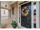 Charming front door with a decorative floral wreath and brick facade at 1903 Brackendale Nw Rd, Kennesaw, GA 30152