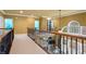 Open hallway with neutral carpet and wood banister that overlooks the living room and leads to the bedroom at 1903 Brackendale Nw Rd, Kennesaw, GA 30152