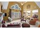 Spacious living room featuring large windows, a stone fireplace, and elegant decor at 1903 Brackendale Nw Rd, Kennesaw, GA 30152