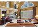 Bright and open living room with a stone fireplace, large windows, and elegant furnishings at 1903 Brackendale Nw Rd, Kennesaw, GA 30152
