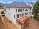 Beige two-story home showing deck with stairs leading to the backyard and basement entrance at 1903 Brackendale Nw Rd, Kennesaw, GA 30152