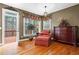 Cozy sitting area with a plush chair, dresser, and a view to an outdoor deck through a window at 1903 Brackendale Nw Rd, Kennesaw, GA 30152