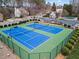 Two well-maintained blue tennis courts in a fenced area, alongside the neighborhood pool at 1903 Brackendale Nw Rd, Kennesaw, GA 30152