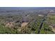 An aerial perspective of multiple properties, revealing vast wooded areas, each with its own generous land plot at 1312 Mcgarity Rd, Temple, GA 30179