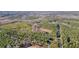 Aerial view of the property, showcasing surrounding wooded areas and a vast amount of land with mature trees at 1312 Mcgarity Rd, Temple, GA 30179