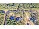 Aerial view showcases land with wooded acreage including two homes and a circular drive on a rural road at 1312 Mcgarity Rd, Temple, GA 30179