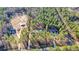 Areal view of multiple houses situated on heavily wooded lots and bordered by dark lines at 1312 Mcgarity Rd, Temple, GA 30179