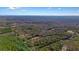 Extensive wooded acreage showcasing potential home sites nestled among mature trees, captured in a breathtaking aerial shot at 1312 Mcgarity Rd, Temple, GA 30179