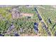 Discover vast acreage with mature trees, perfect for a private retreat, as seen from this high altitude aerial view at 1312 Mcgarity Rd, Temple, GA 30179