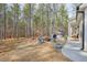 Spacious backyard featuring a firepit, wooded lot and patio at 1312 Mcgarity Rd, Temple, GA 30179