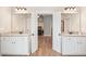 Dual vanity bathroom with granite counters, white cabinets, and an open doorway offers a spa-like experience at 1312 Mcgarity Rd, Temple, GA 30179