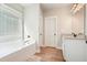 Bright bathroom features a tub with a window and a vanity with granite countertops at 1312 Mcgarity Rd, Temple, GA 30179