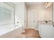 Inviting bathroom features a soaking tub, granite counters, and white cabinets to create a relaxing retreat at 1312 Mcgarity Rd, Temple, GA 30179