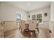 Dining room with brick accent walls, wood floors, windows, and upholstered chairs around wooden table at 1312 Mcgarity Rd, Temple, GA 30179
