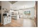 Open kitchen with white cabinets, island seating, and stainless steel appliances at 1312 Mcgarity Rd, Temple, GA 30179