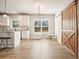 Bright kitchen features white cabinets, an island with seating, and a sliding barn door at 1312 Mcgarity Rd, Temple, GA 30179