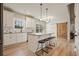 Bright kitchen features white cabinets, granite counters, subway tile backsplash, island with seating and sliding barn door at 1312 Mcgarity Rd, Temple, GA 30179