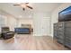 Spacious main bedroom boasts a sitting area with leather recliner, wood floors, and decorative dresser at 1312 Mcgarity Rd, Temple, GA 30179