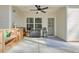 Covered back porch with ceiling fan, an outdoor kitchen, and stylish blue patterned rug at 1312 Mcgarity Rd, Temple, GA 30179