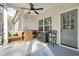 Covered porch with ceiling fan, an outdoor kitchen, and stylish blue patterned rug at 1312 Mcgarity Rd, Temple, GA 30179