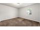 A simple bedroom with neutral walls, carpet, a window, and a ceiling light at 30 Ponders Se Rd, Cartersville, GA 30121