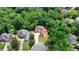 Aerial view of a beautiful house nestled among lush green trees in a quiet, wooded neighborhood at 4580 Lakefield Bend Bnd, Berkeley Lake, GA 30096