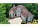 Bird's-eye view of a home with a large driveway, well-maintained landscaping, and a charming facade at 4580 Lakefield Bend Bnd, Berkeley Lake, GA 30096
