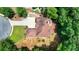 Overhead view of a house with a deck, driveway, and surrounding greenery at 4580 Lakefield Bend Bnd, Berkeley Lake, GA 30096