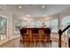 A bar area with seating, large windows, and views of the trees outside at 4580 Lakefield Bend Bnd, Berkeley Lake, GA 30096