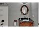 Bathroom featuring an oval mirror above a vanity with decorative woodworking and shower at 4580 Lakefield Bend Bnd, Berkeley Lake, GA 30096