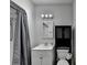 Compact bathroom features a shower and tub with vanity sink and medicine cabinet at 4580 Lakefield Bend Bnd, Berkeley Lake, GA 30096