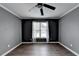 A bedroom featuring wood-look floors, a ceiling fan, crown molding and natural light at 4580 Lakefield Bend Bnd, Berkeley Lake, GA 30096